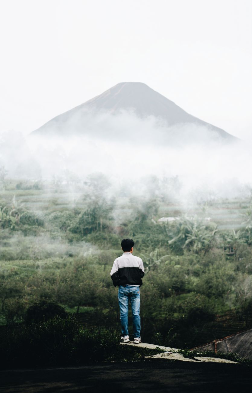 Editorial photographer observing misty valley
